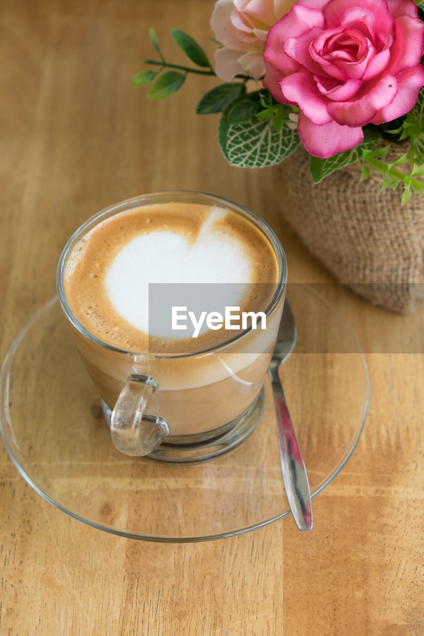 COFFEE CUP ON TABLE AGAINST WALL AT HOME