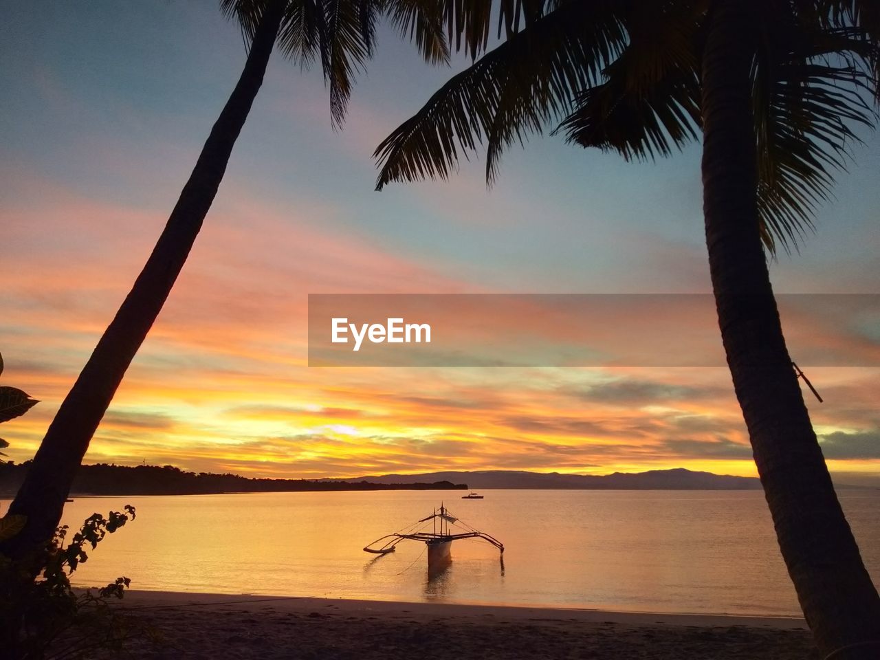 SCENIC VIEW OF BEACH DURING SUNSET