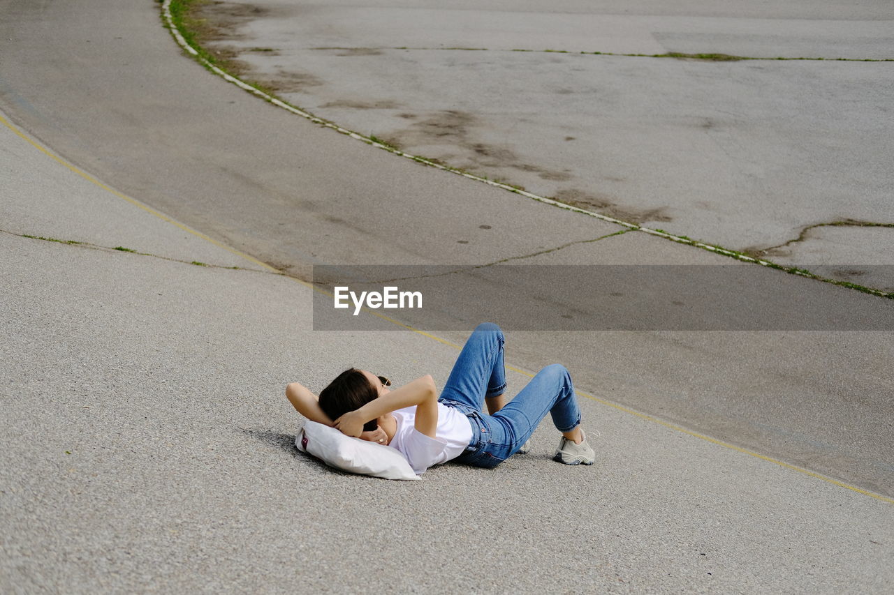 High angle view of woman lying down outdoors