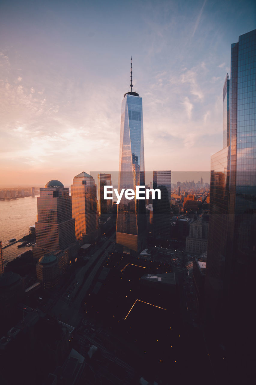 Modern buildings against sky during sunset