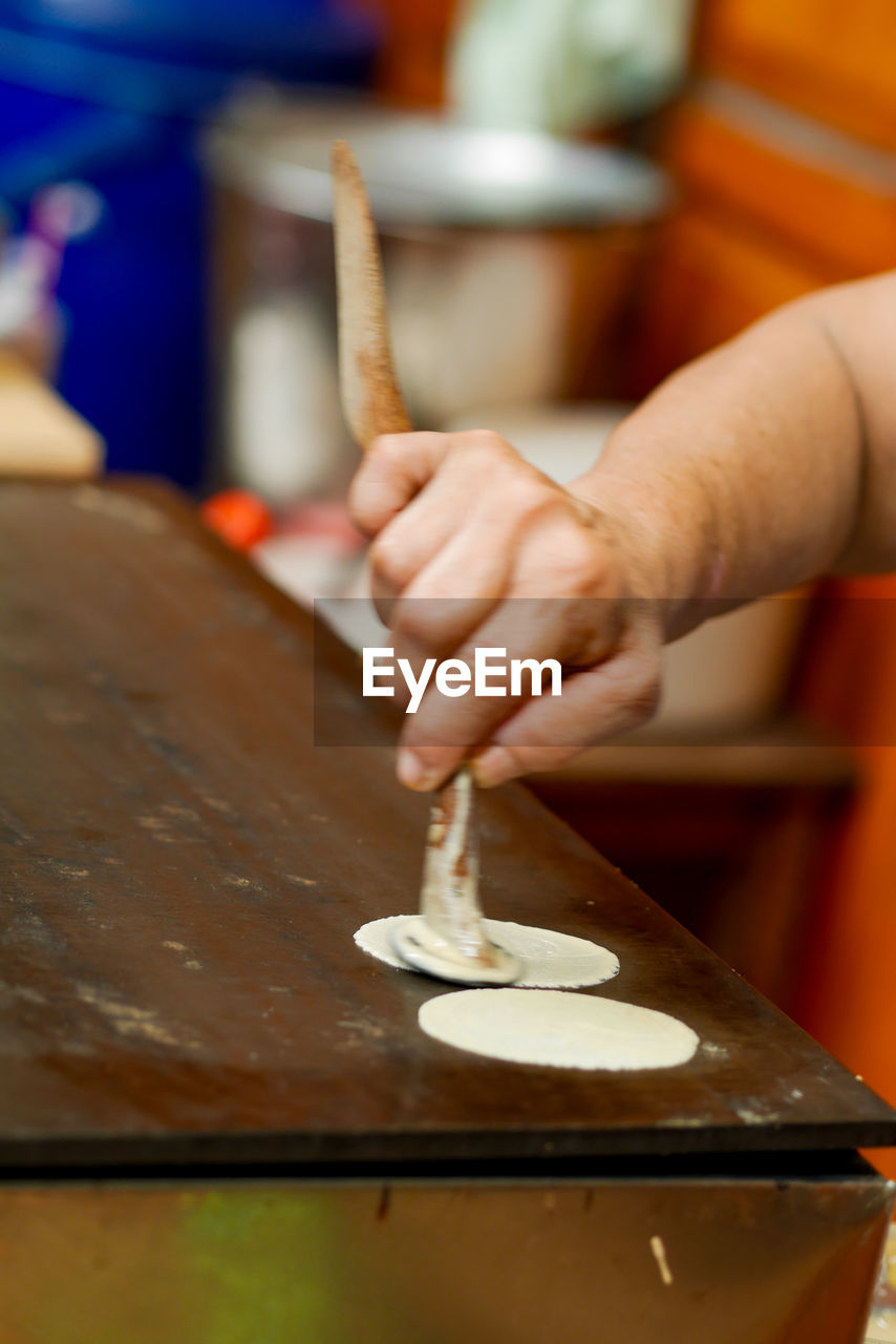 hand, one person, skill, indoors, occupation, craft, wood, food, adult, working, baked, close-up, craftsperson, holding, creativity, workshop, art, making, focus on foreground, instrument maker, business, accuracy, expertise, food and drink, selective focus