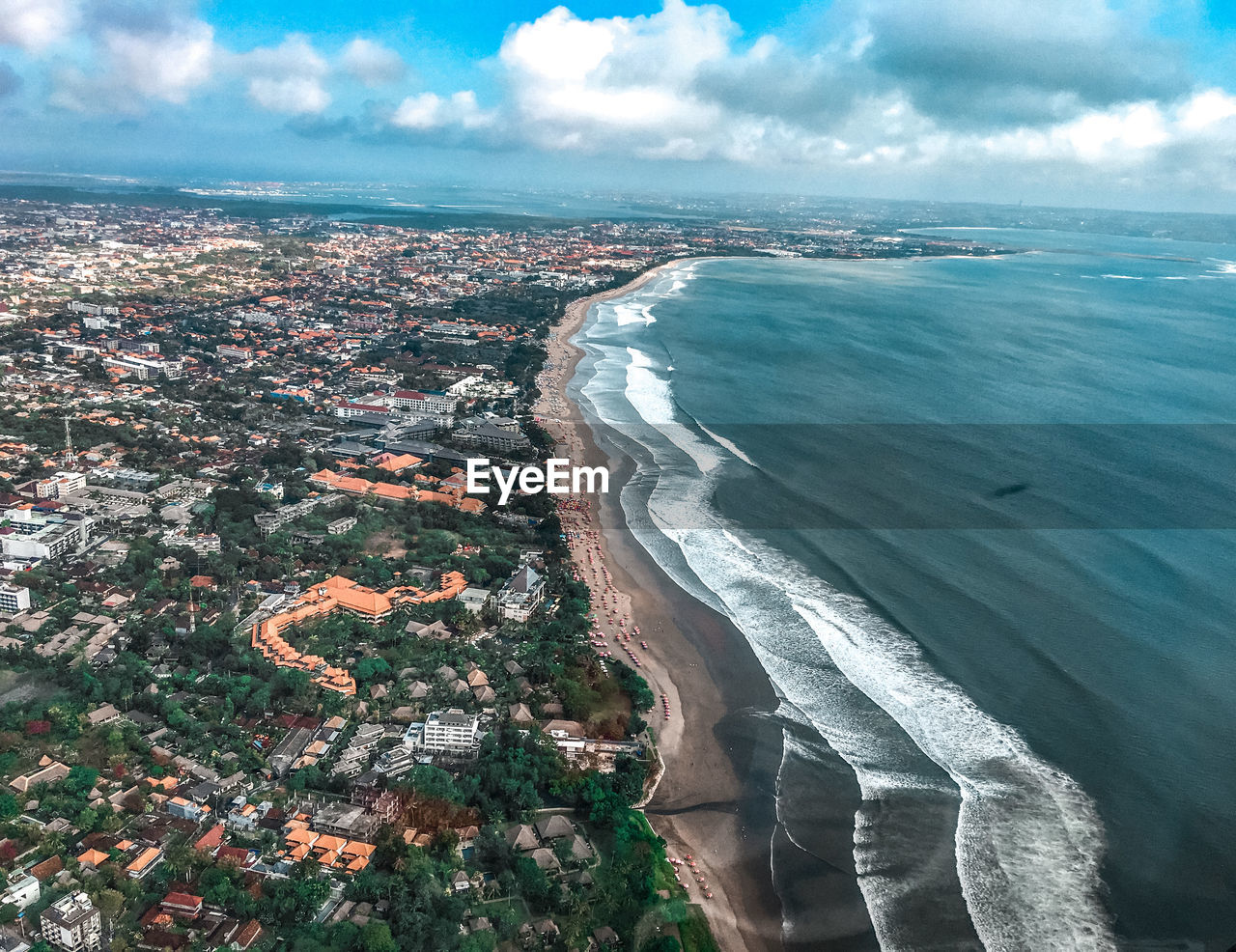 High angle view of city by sea against sky