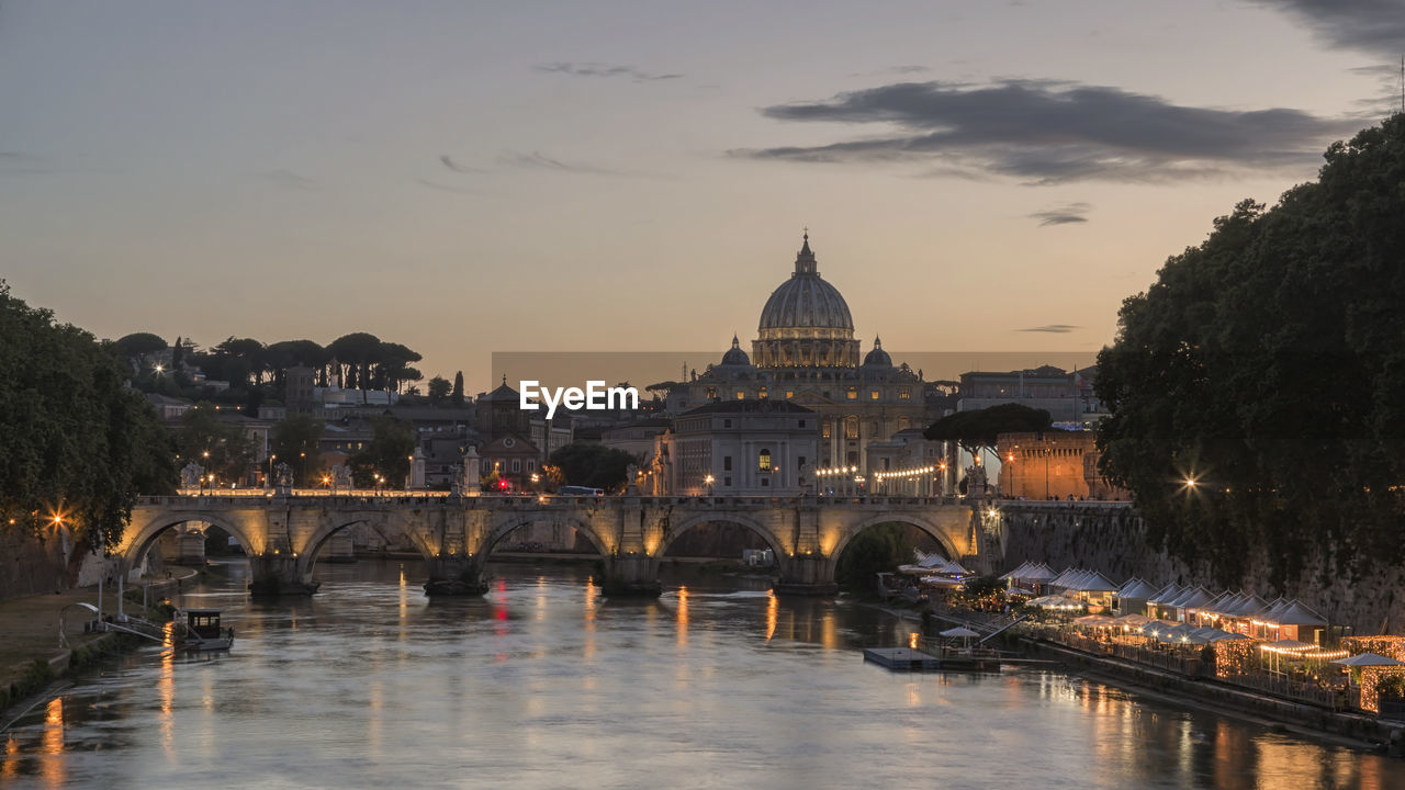Ponte sant angelo over tiber river in city during sunset