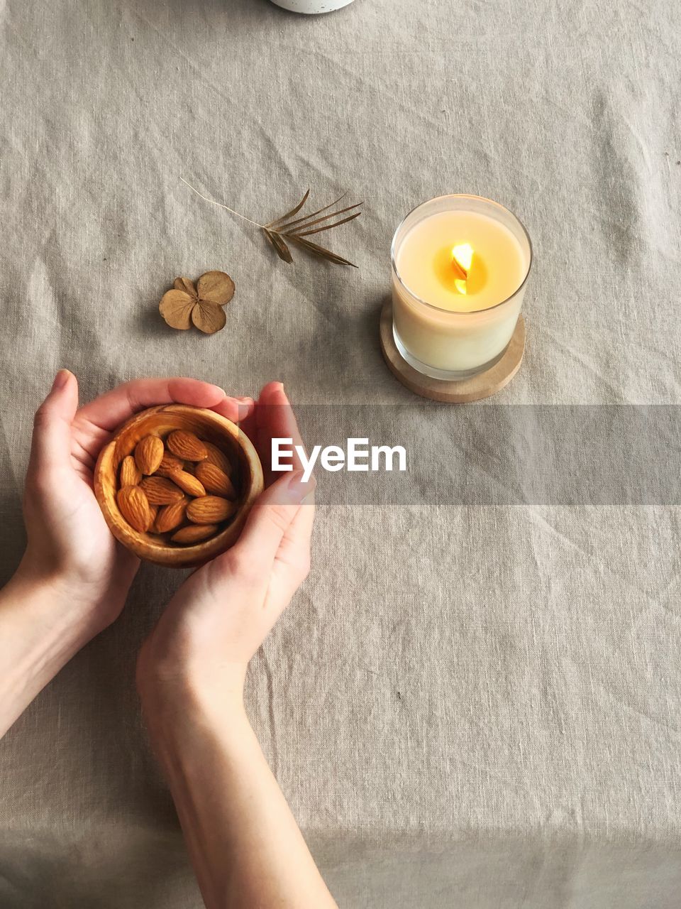 High angle view of hand holding tea cup on table