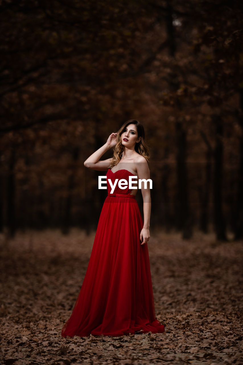 Young woman standing in a forest