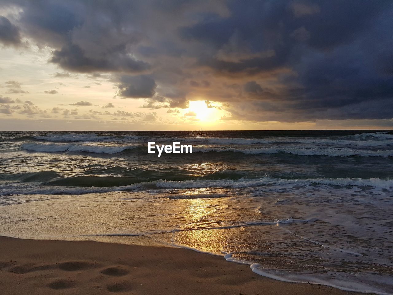 SCENIC VIEW OF BEACH DURING SUNSET