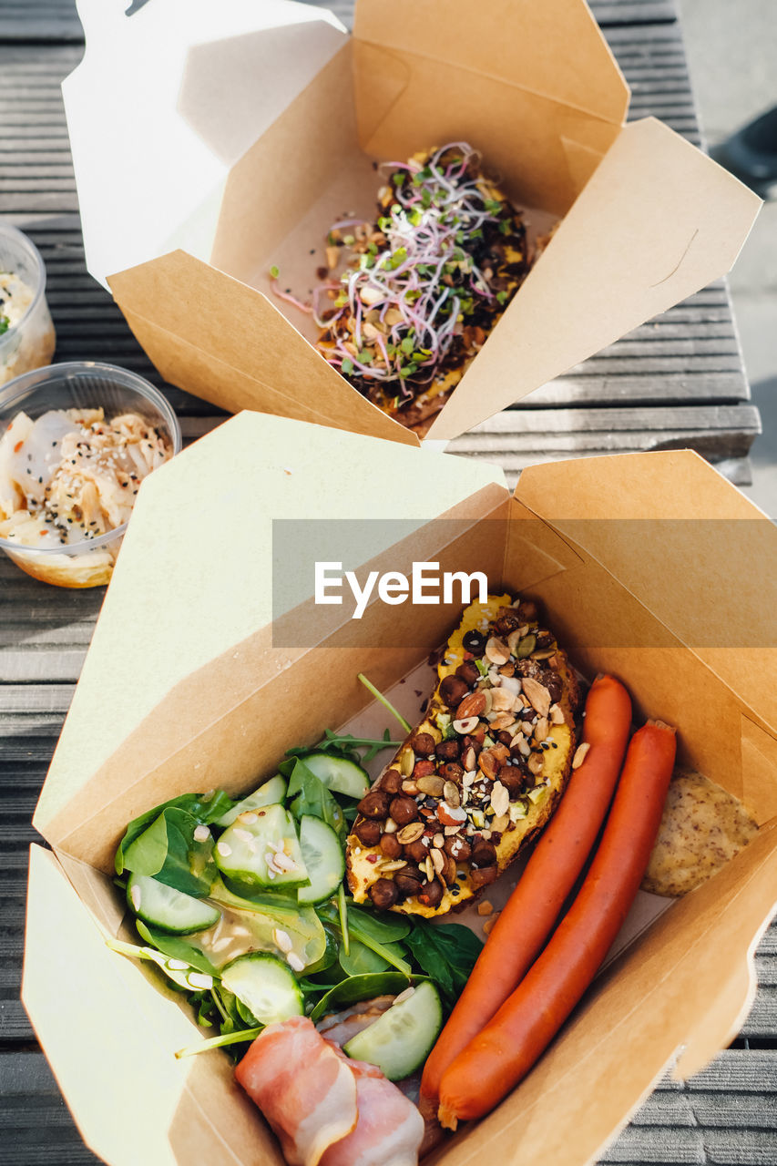 High angle view of food in box outside, take away breakfast.