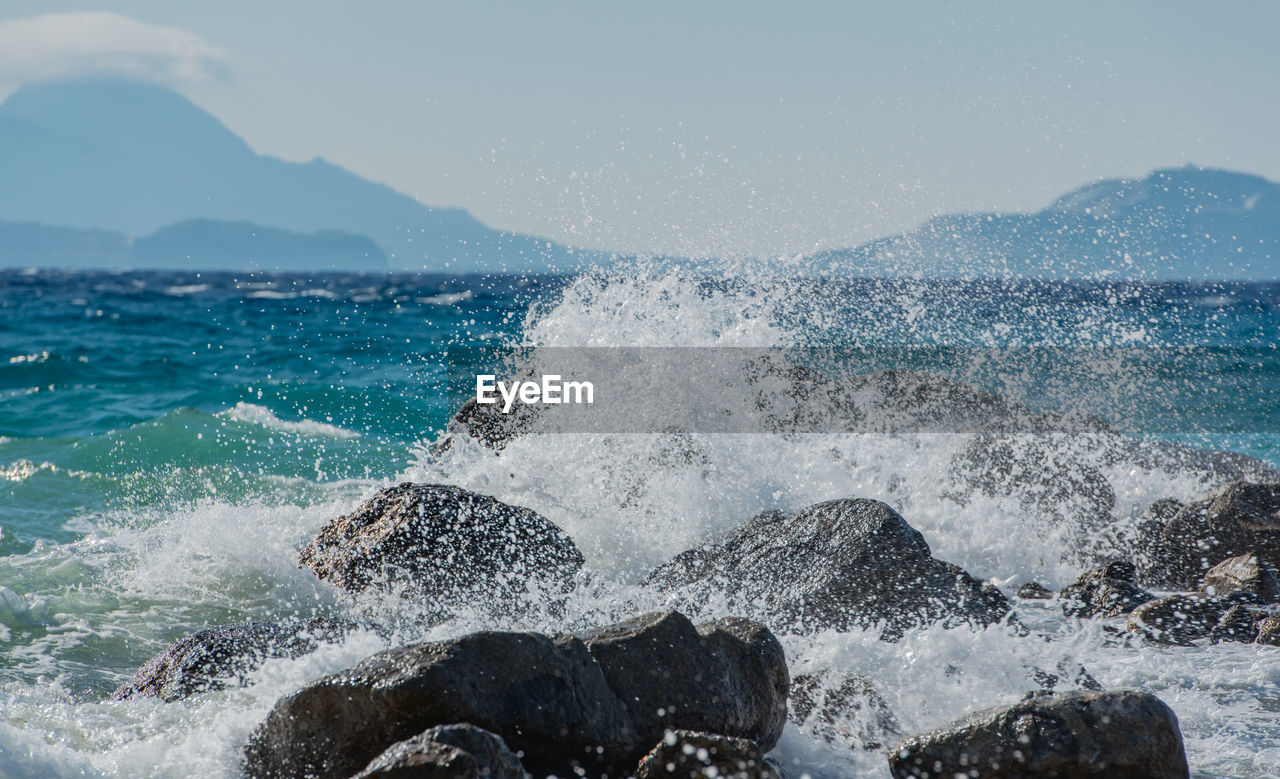 Waves at storm in mediterranean sea beating on breakwater on kos greece