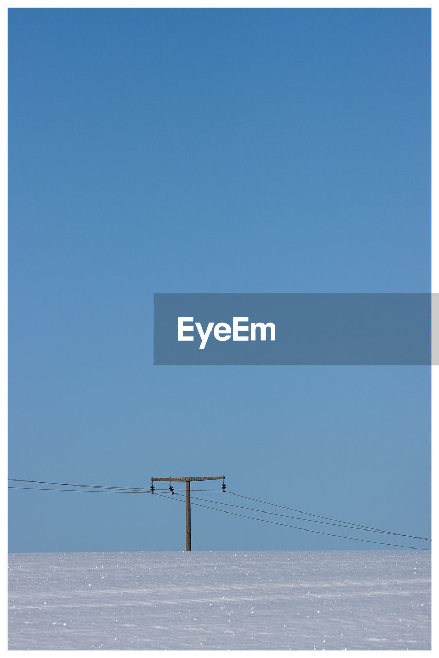 LOW ANGLE VIEW OF CLEAR BLUE SKY OVER SNOW AGAINST THE BACKGROUND