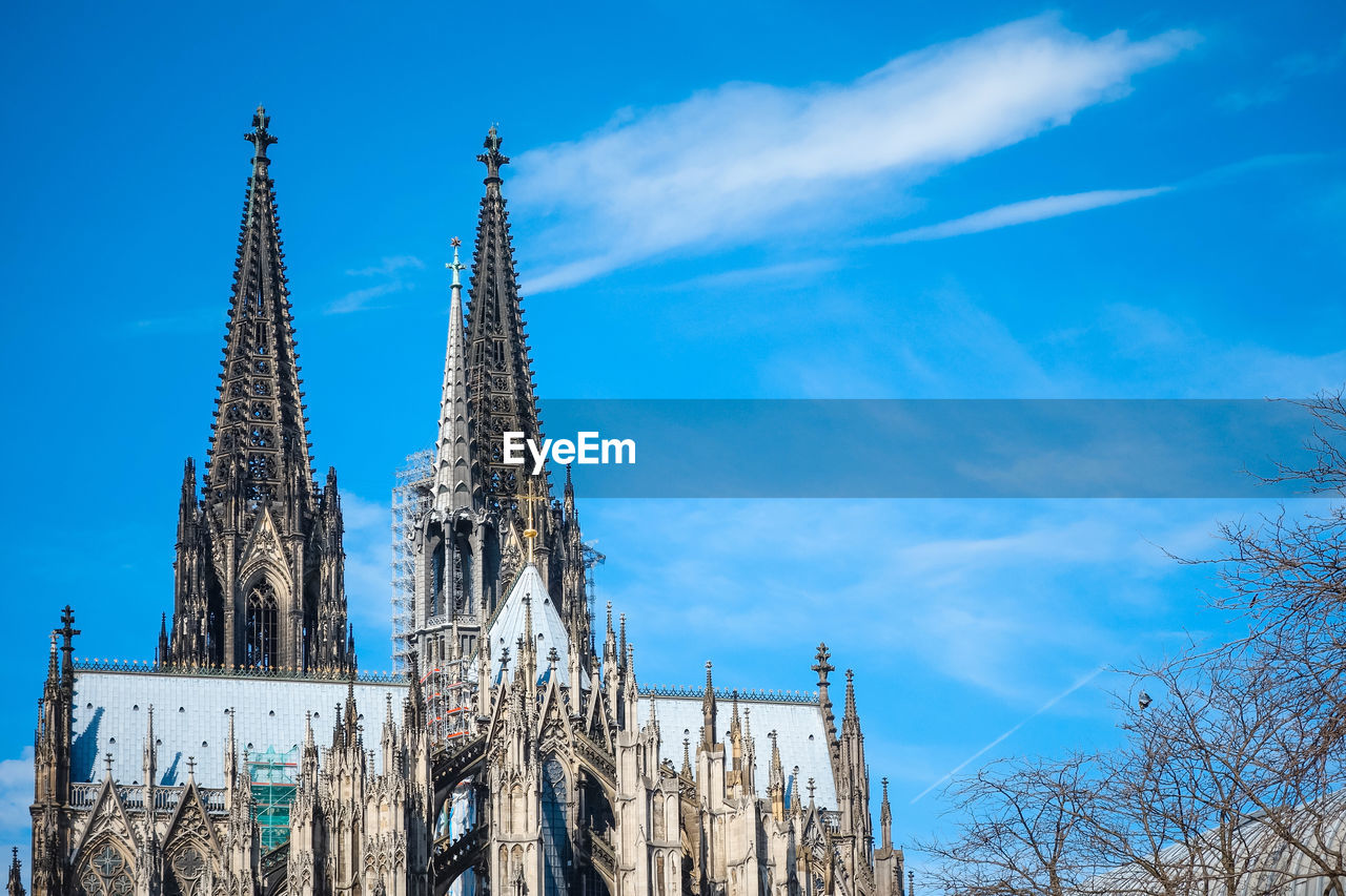 Low angle view of cologne cathedral against cloudy sky