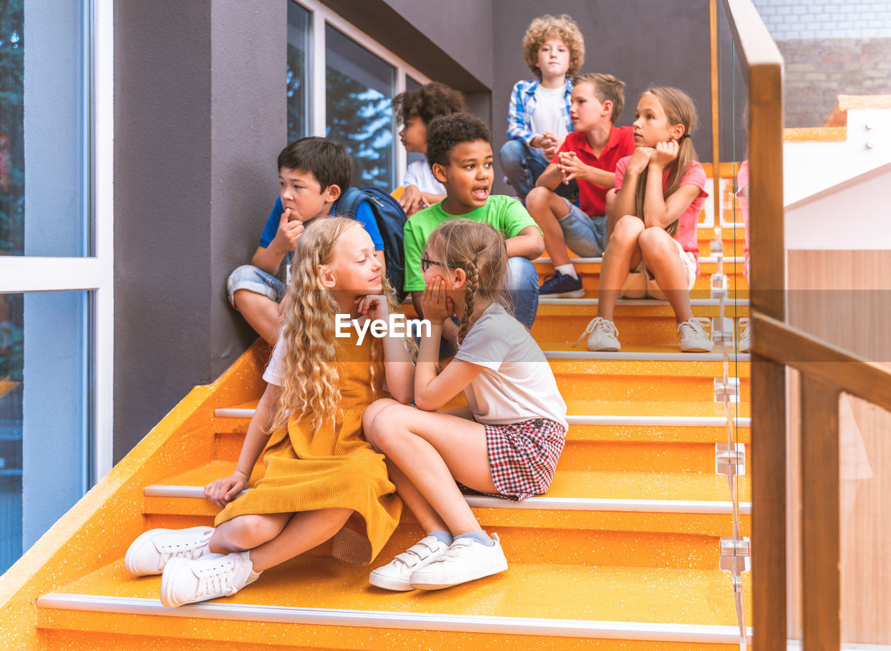 Friends sitting on staircase