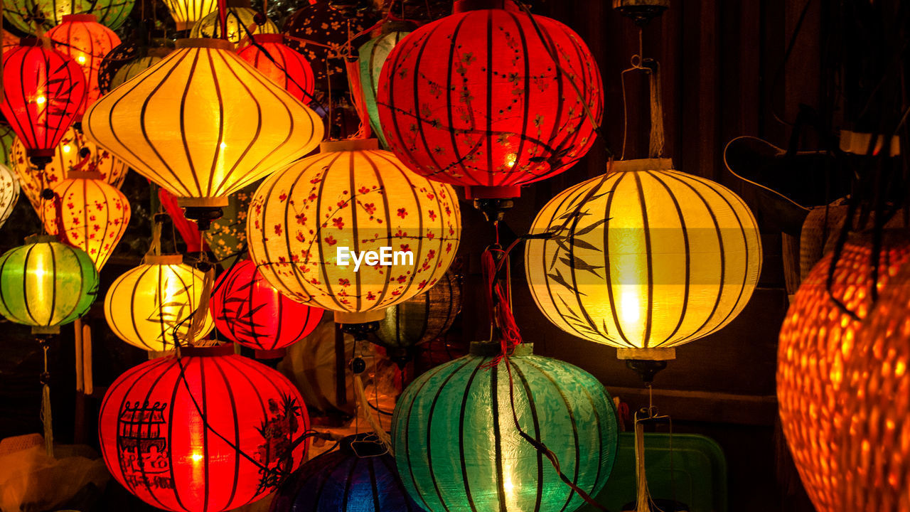 Illuminated lanterns hanging for sale in store