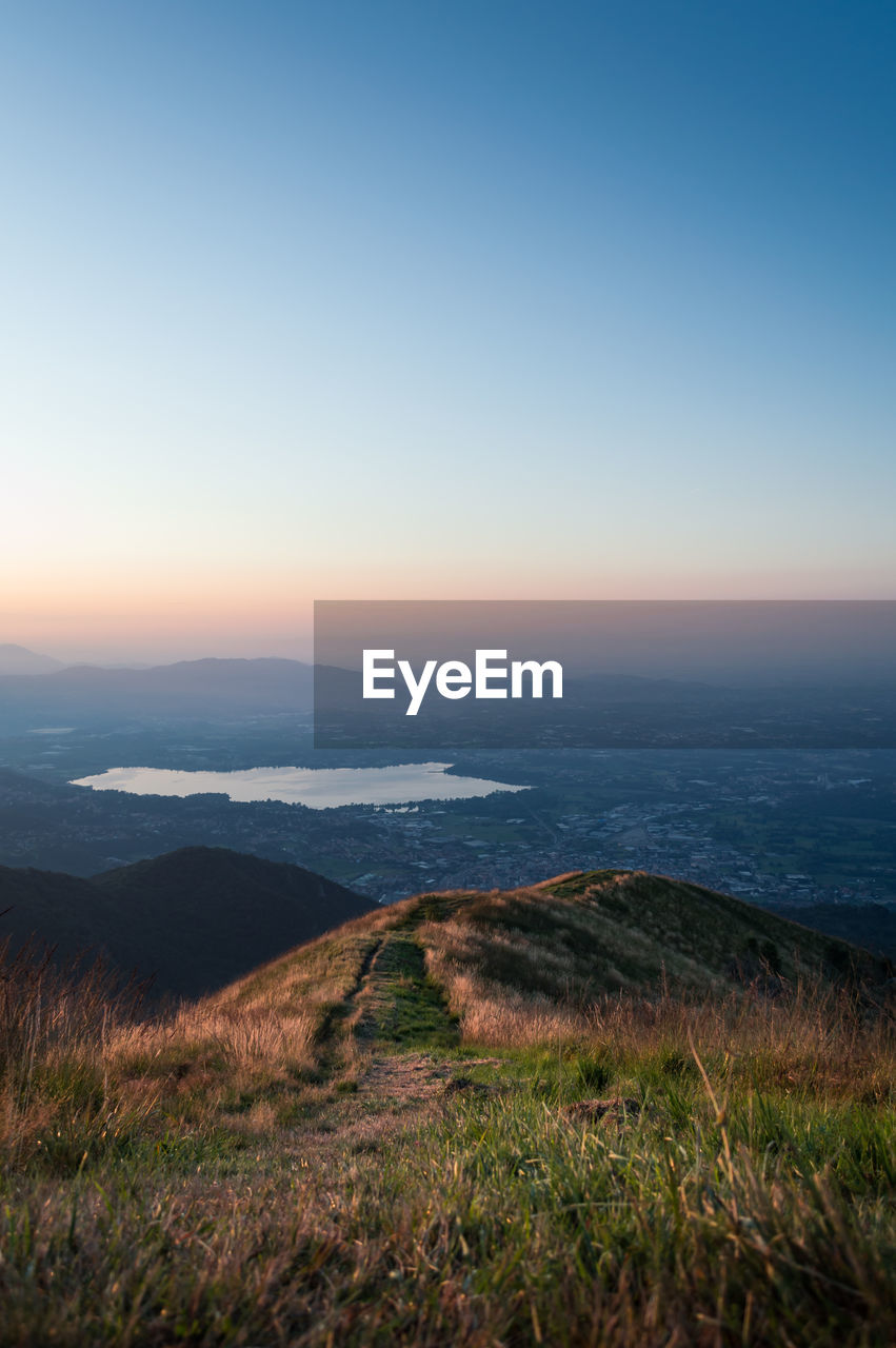 Scenic view of landscape against clear sky during sunset