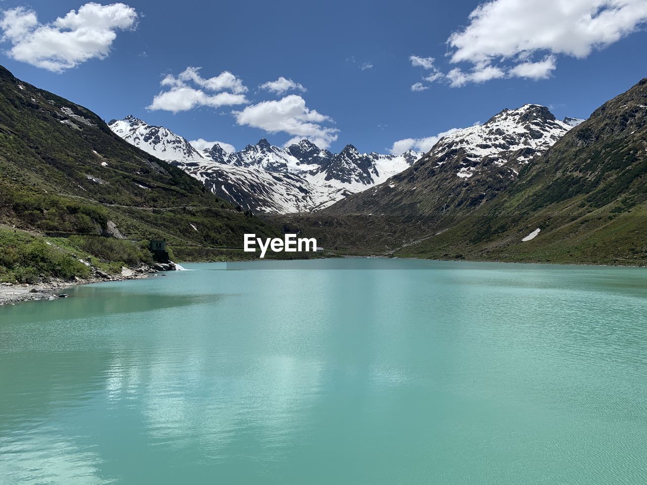 Scenic view of lake and mountains against sky