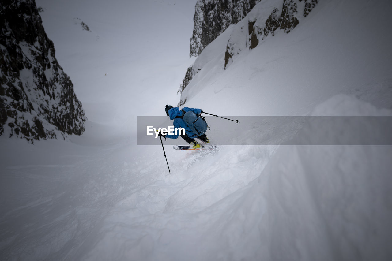Person skiing on snow covered mountain