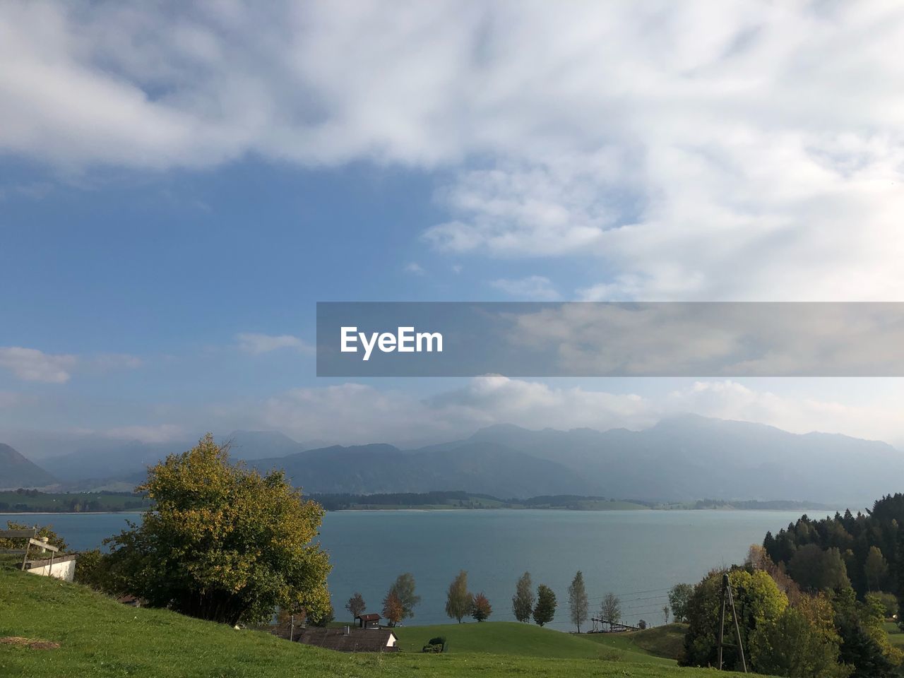 Scenic view of lake and mountains against sky