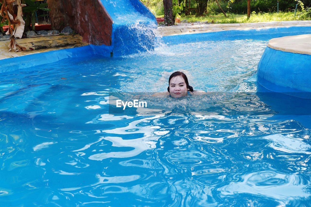 Portrait of woman swimming in pool