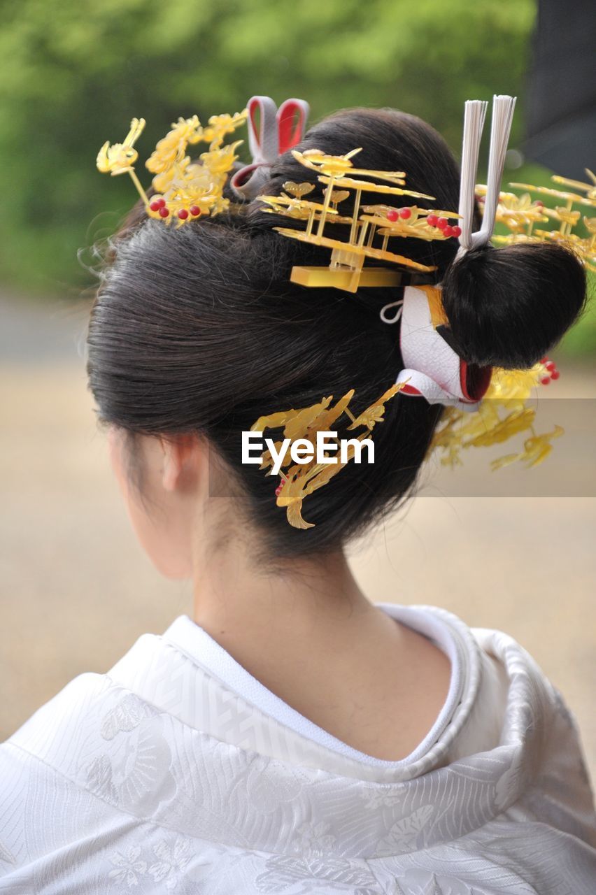 FULL LENGTH REAR VIEW OF WOMAN WITH RED FLOWER