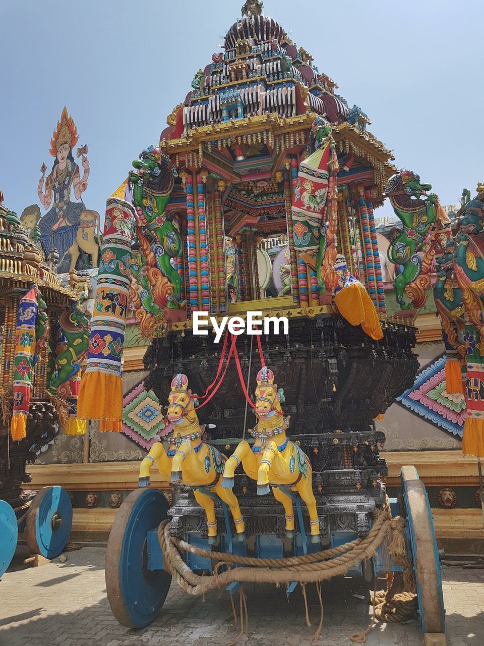 LOW ANGLE VIEW OF CAROUSEL AT AMUSEMENT PARK