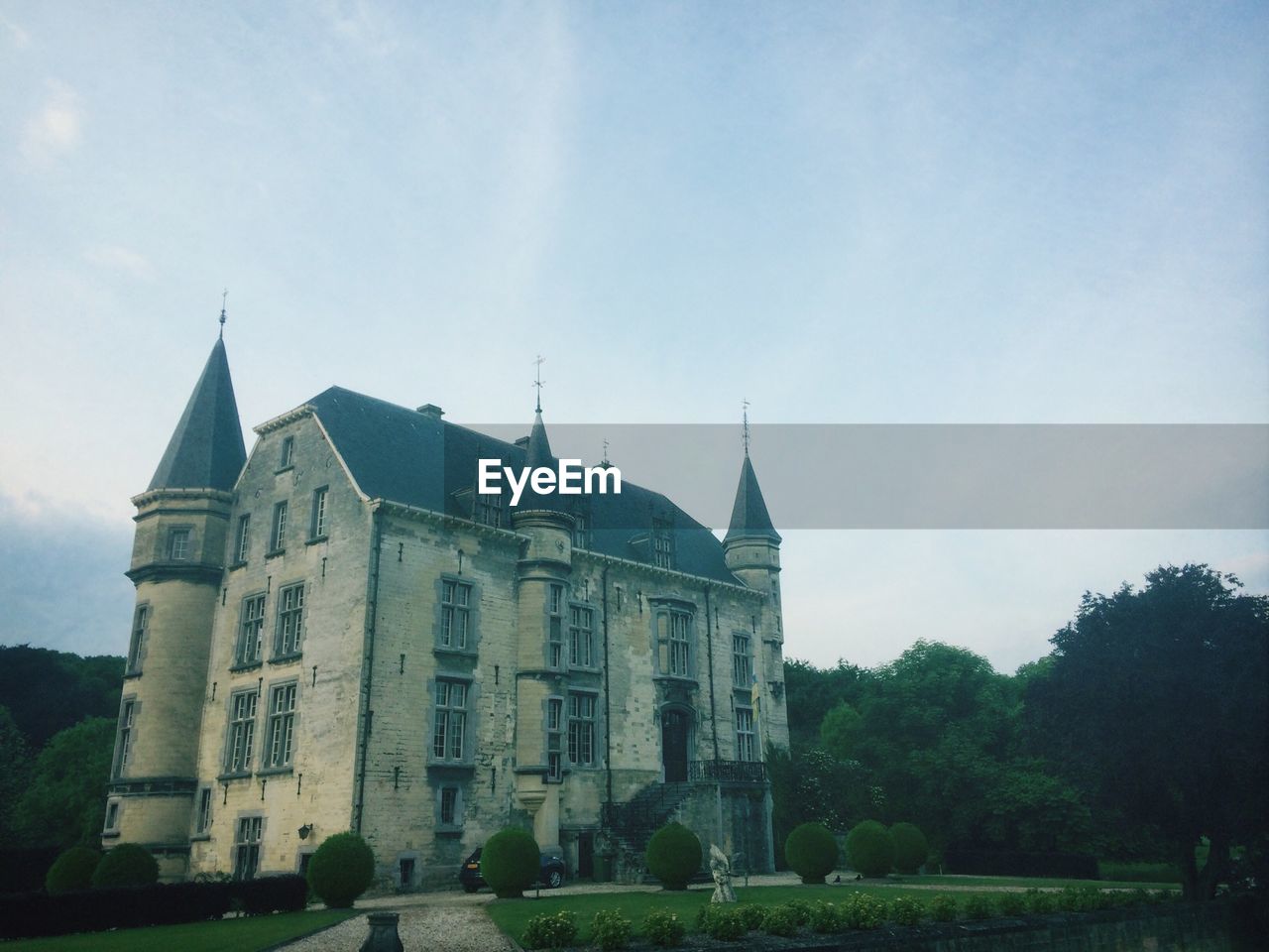 LOW ANGLE VIEW OF CHURCH WITH TREES IN BACKGROUND