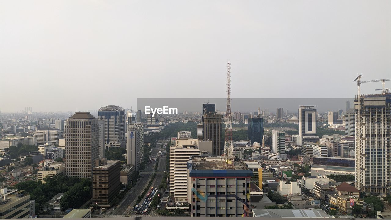 Modern buildings in city against clear sky