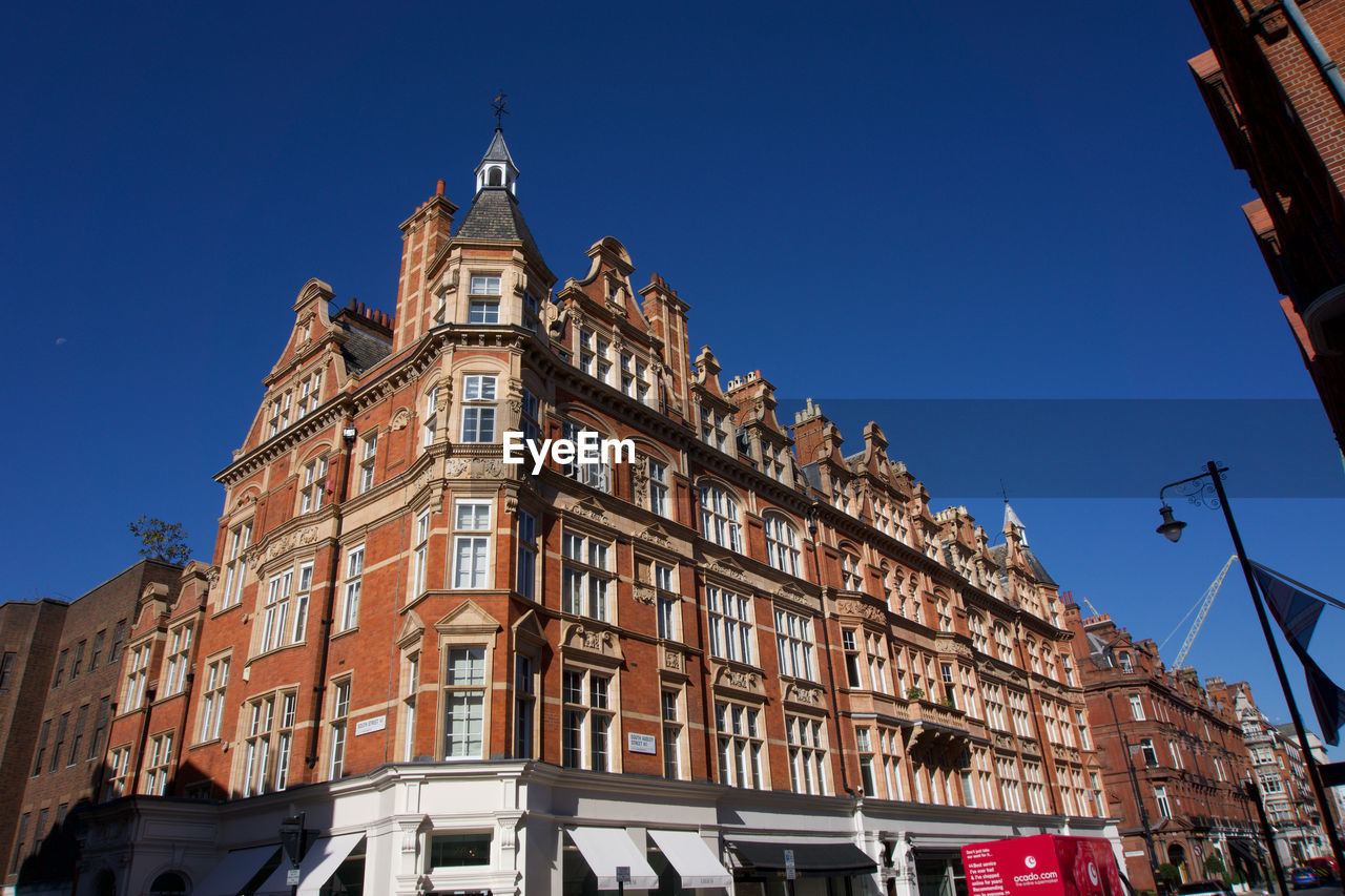 LOW ANGLE VIEW OF BUILDINGS AGAINST CLEAR SKY