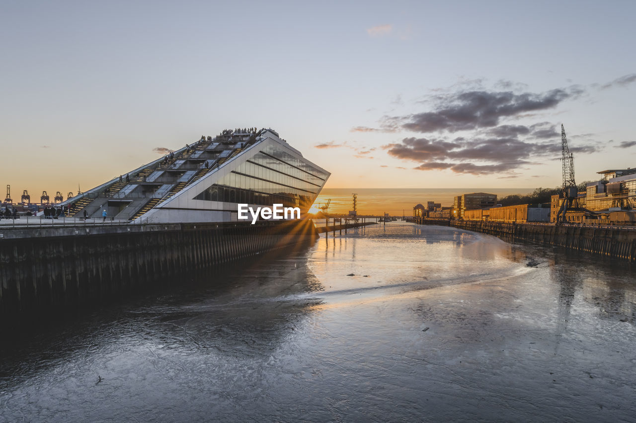 Germany, hamburg, elbe river and dockland ferry terminal at sunrise