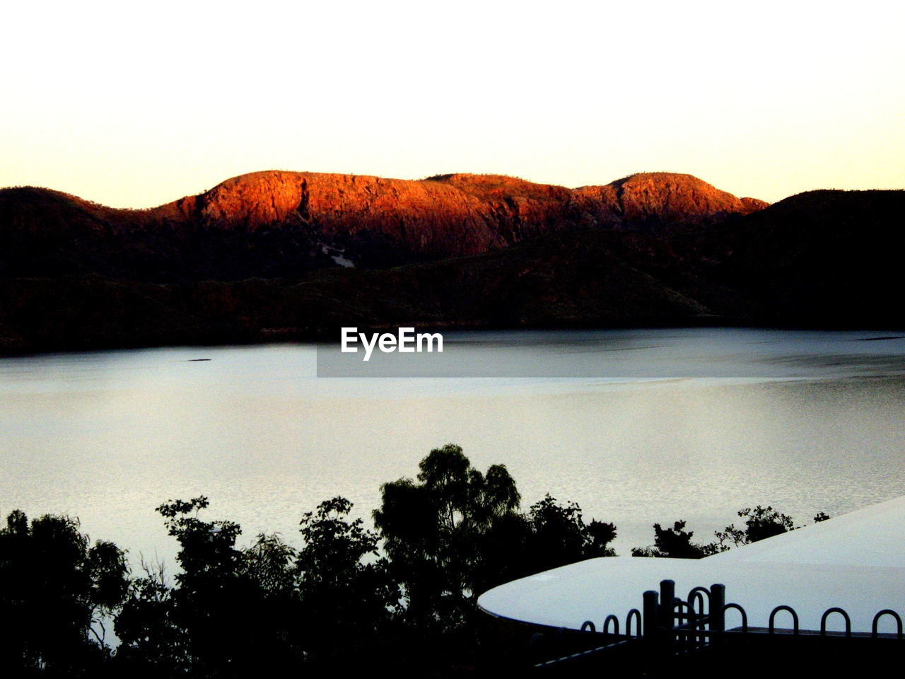 View of calm lake against mountain range