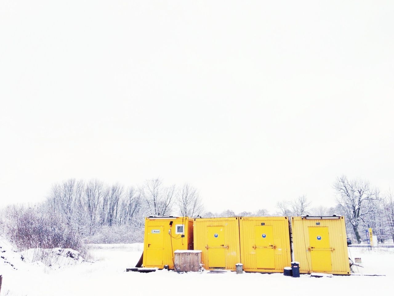 Yellow cabins on snow covered landscape