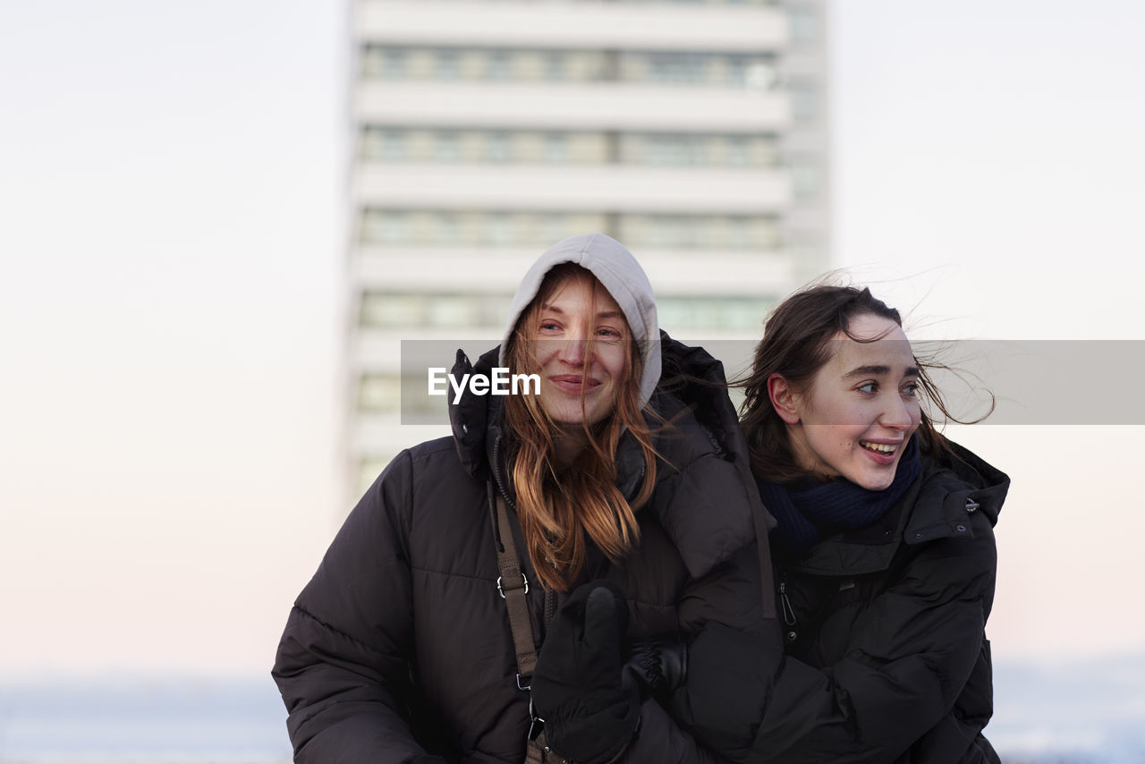 Smiling female couple in winter clothing