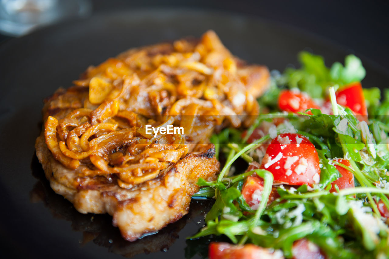 CLOSE-UP OF PASTA WITH MEAT AND SALAD