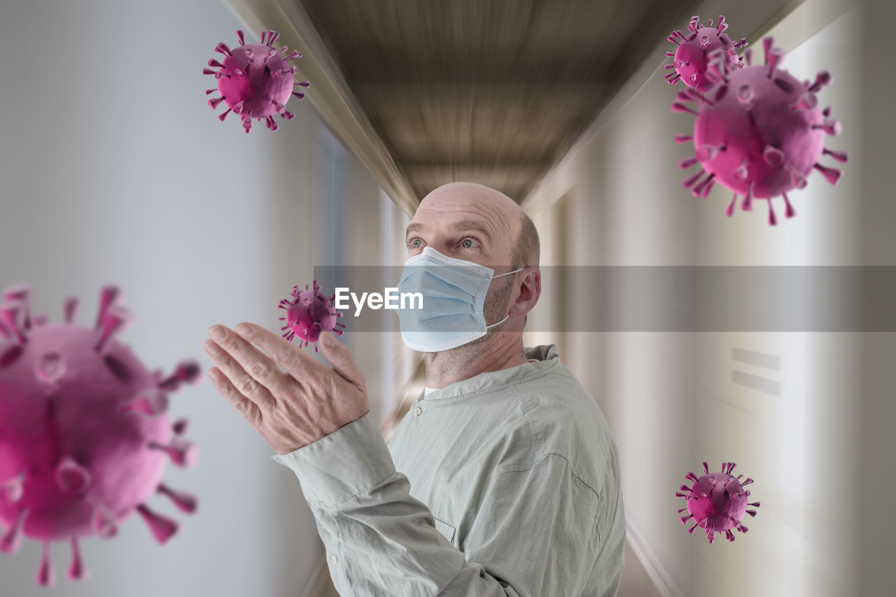 PORTRAIT OF WOMAN WITH PINK FLOWERS IN BOUQUET OF INDOORS