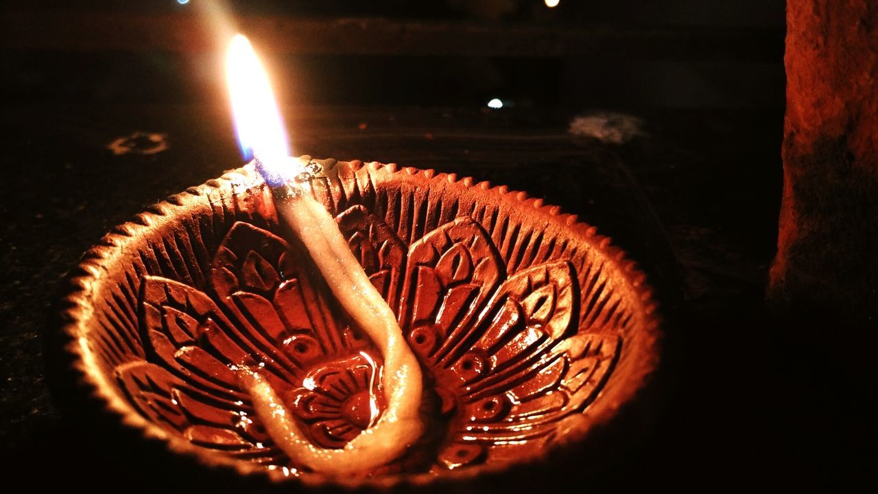 Close-up of lit diya at night