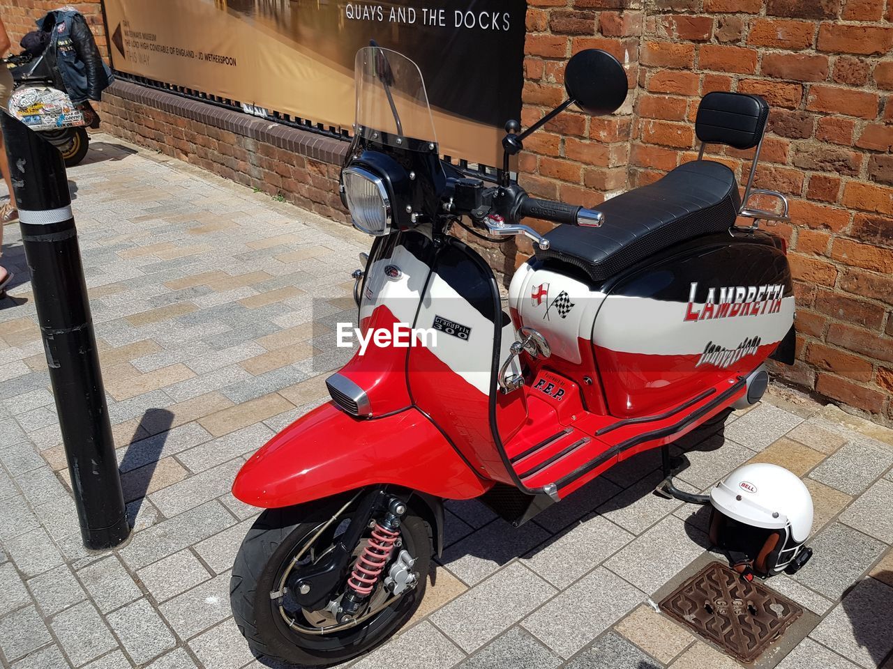 HIGH ANGLE VIEW OF RED MOTOR SCOOTER ON STREET