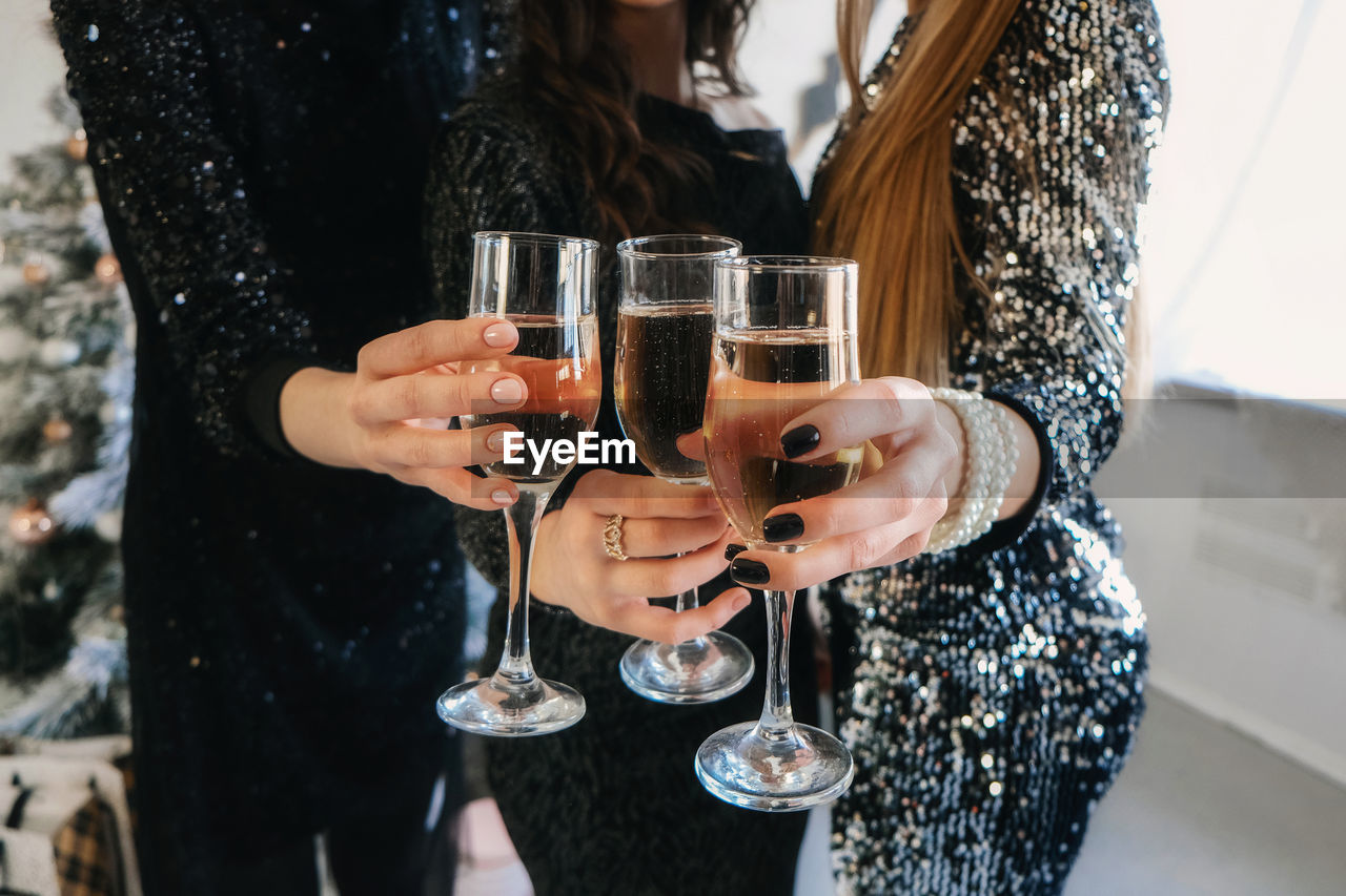 Midsection of woman drinking glass