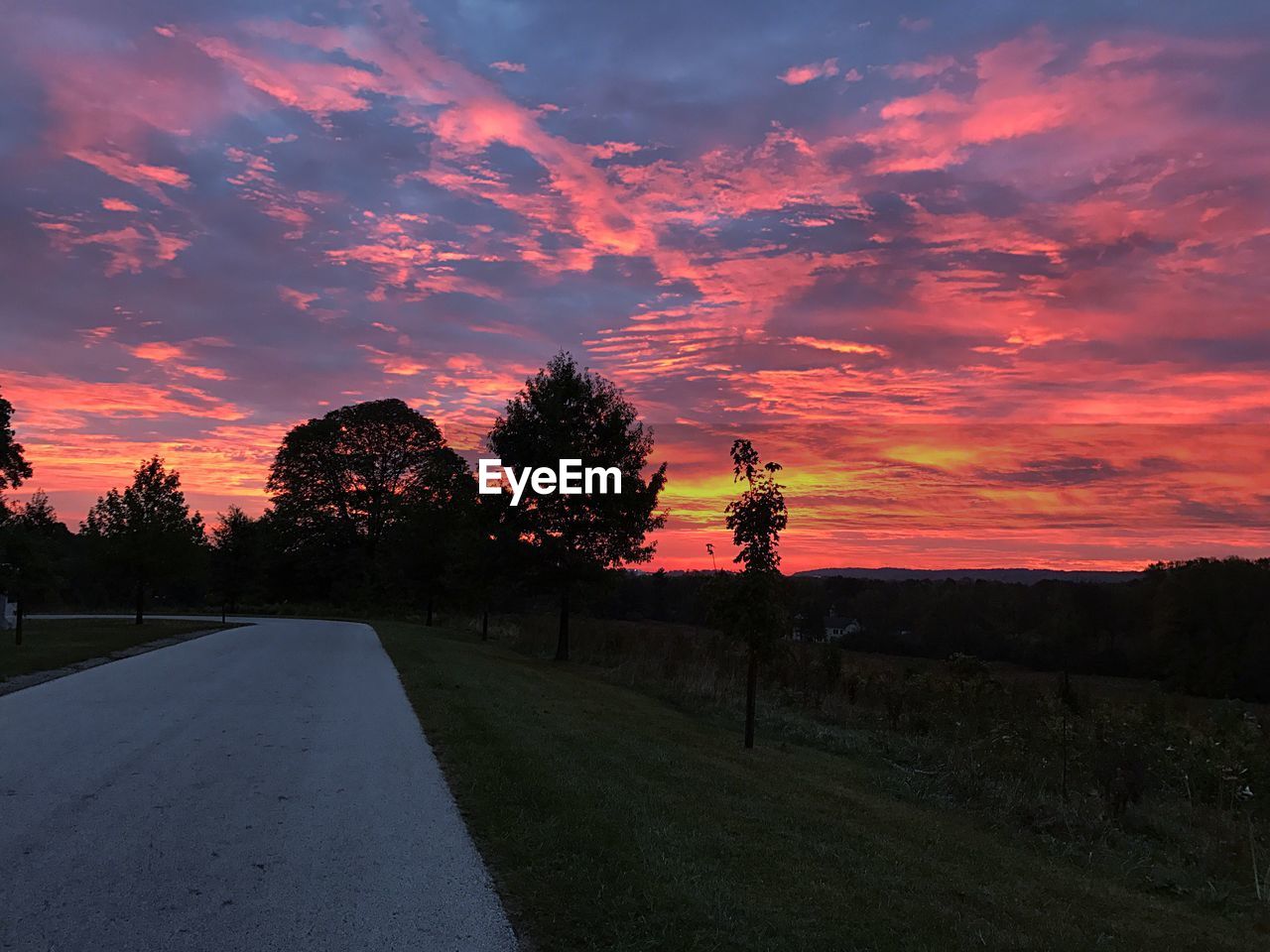 ROAD AGAINST SKY DURING SUNSET