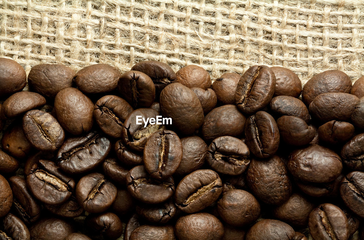 CLOSE-UP OF COFFEE BEANS IN CONTAINER