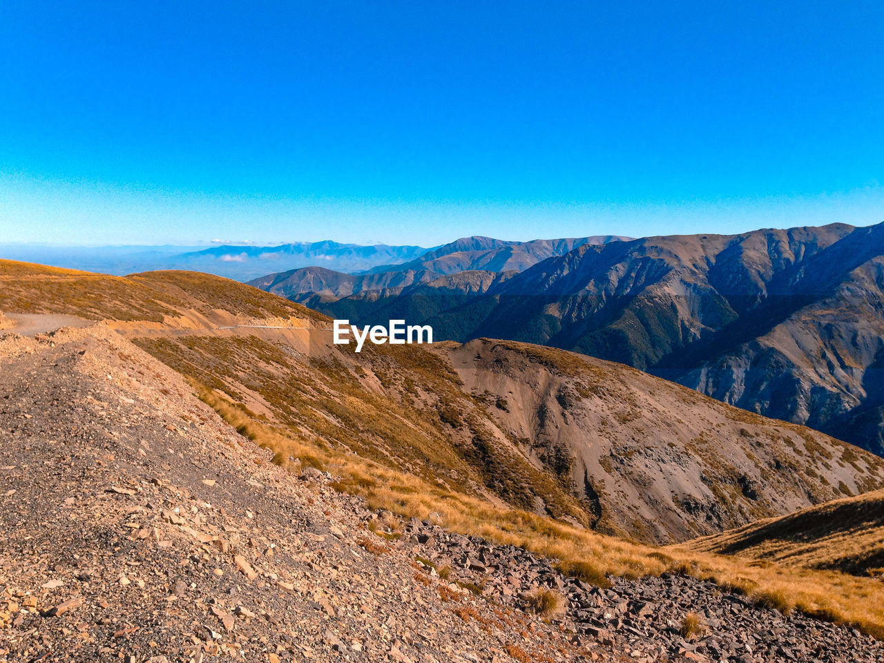 Scenic view of mountains against clear blue sky