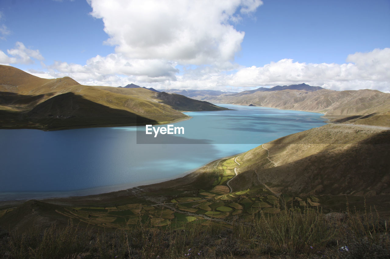 Scenic view of lake and mountains against sky