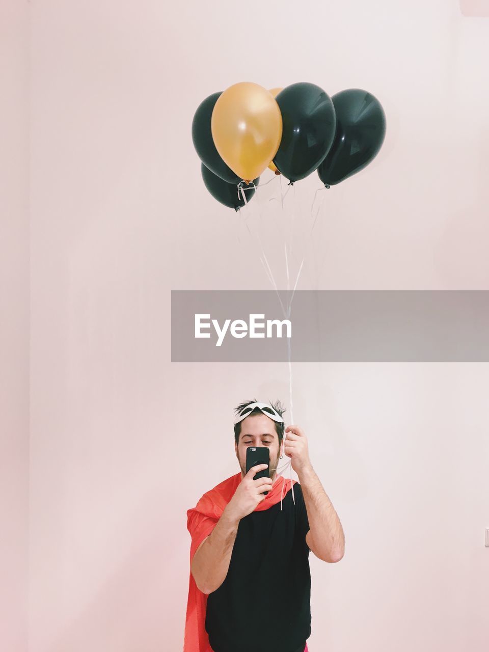 Portrait of young man with balloons