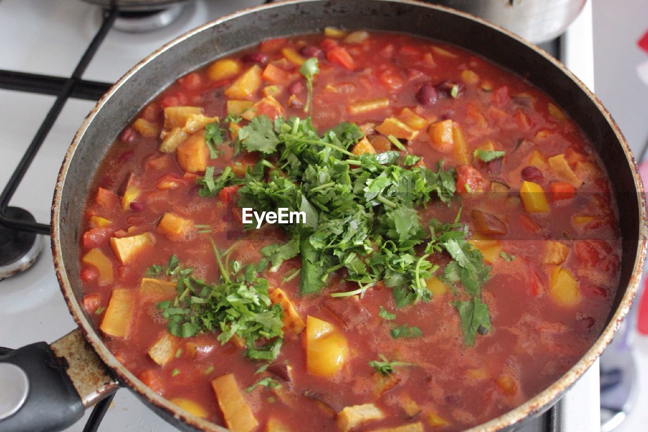 High angle view of sweet potato and chili cooked in pan