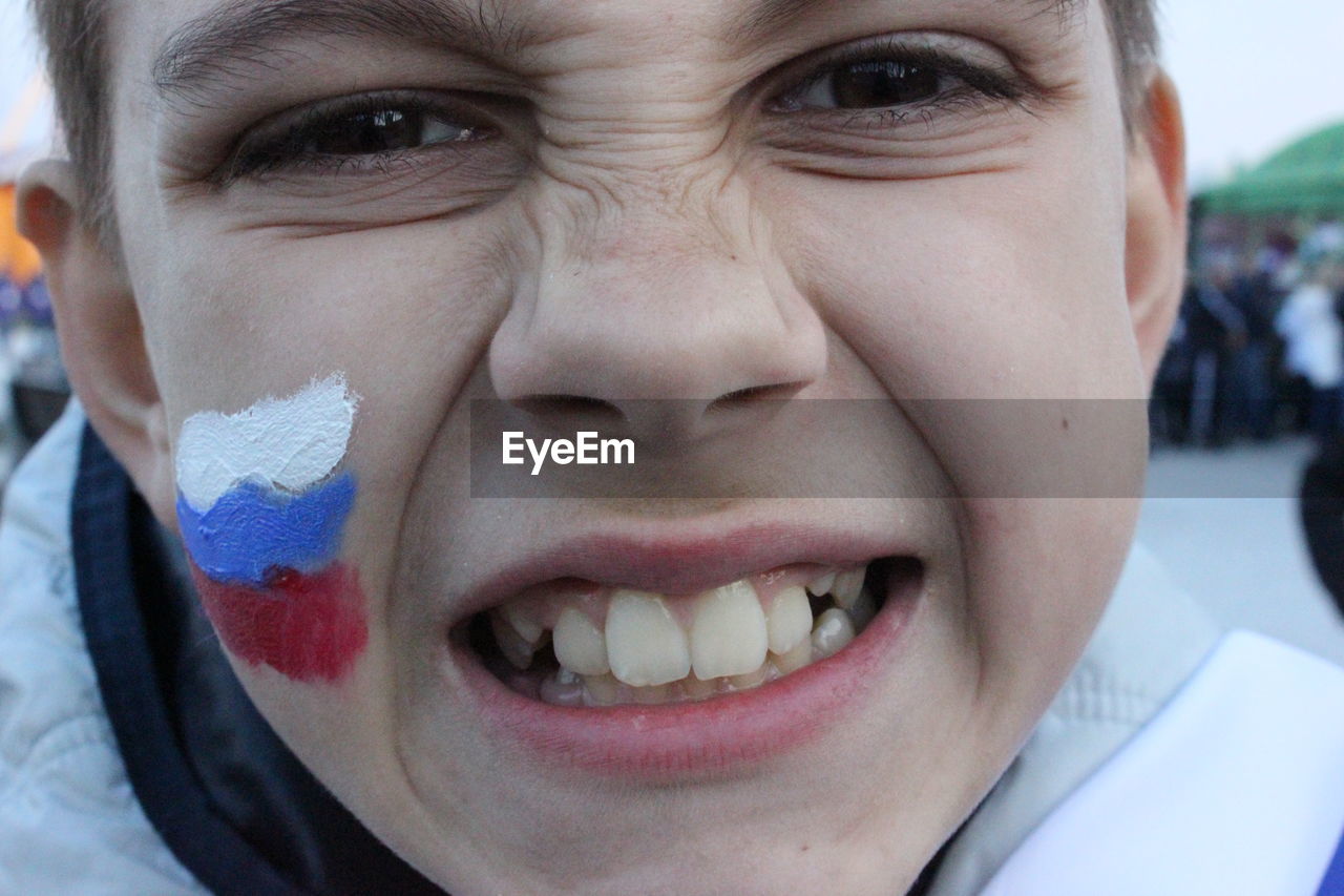 Close-up portrait of teenage boy making face