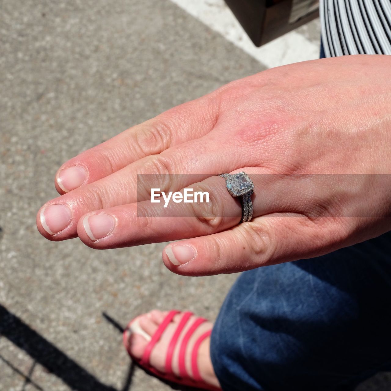 Low section of woman wearing ring