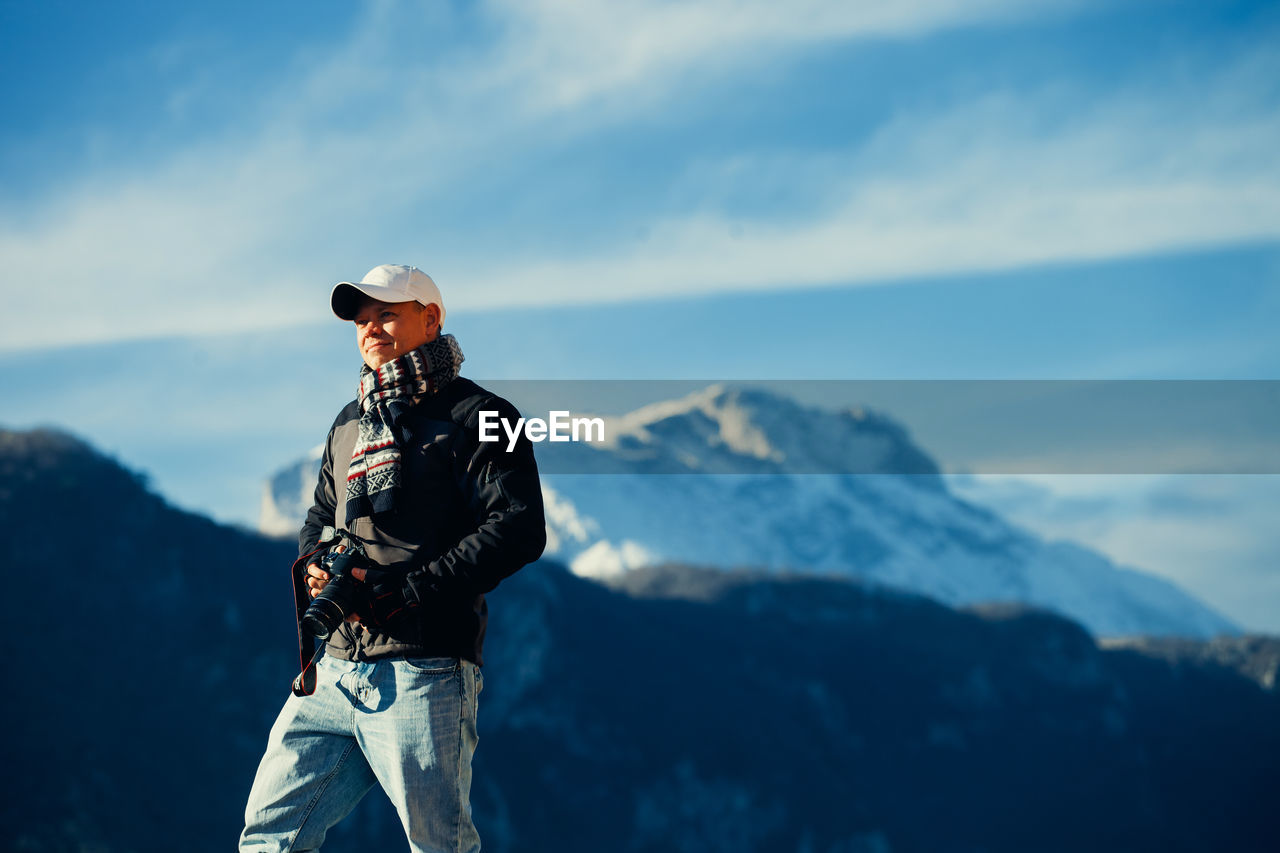 Man standing on mountain against sky