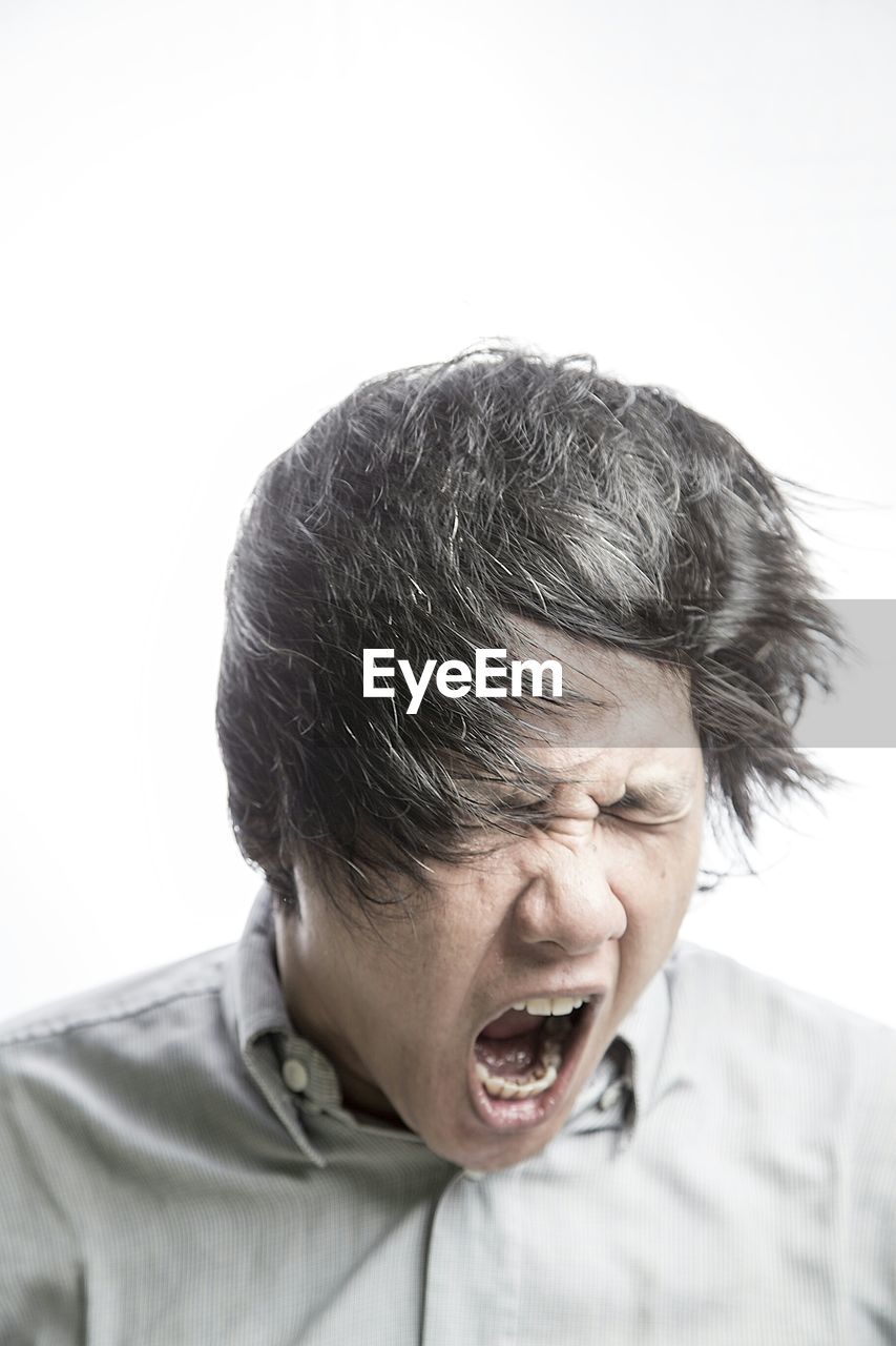 Woman screaming over white background