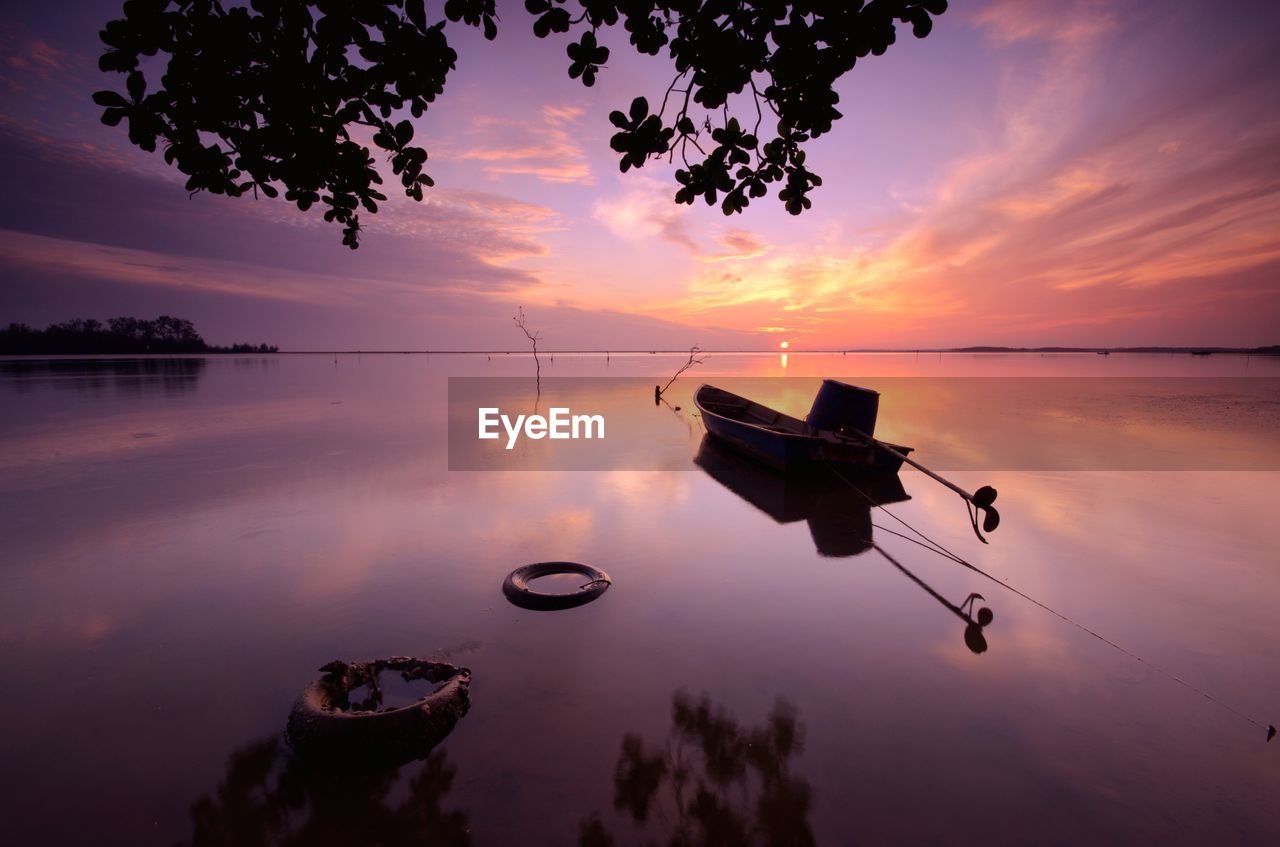 Scenic view of lake against sky during sunset