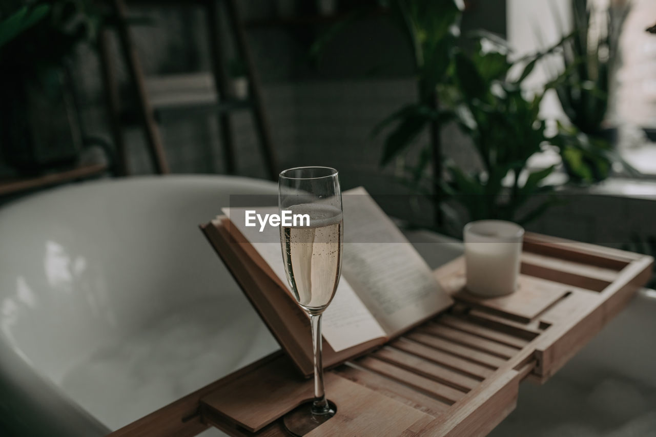 table, food and drink, household equipment, drink, furniture, no people, chair, indoors, seat, cup, drinking glass, refreshment, glass, wood, absence, nature, room, mug, focus on foreground, day, lighting, still life, food, crockery, plant, relaxation, coffee cup, water, coffee table, business