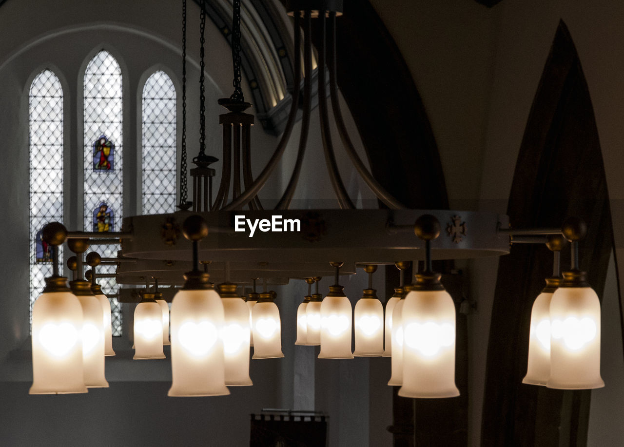 Illuminated chandelier in church