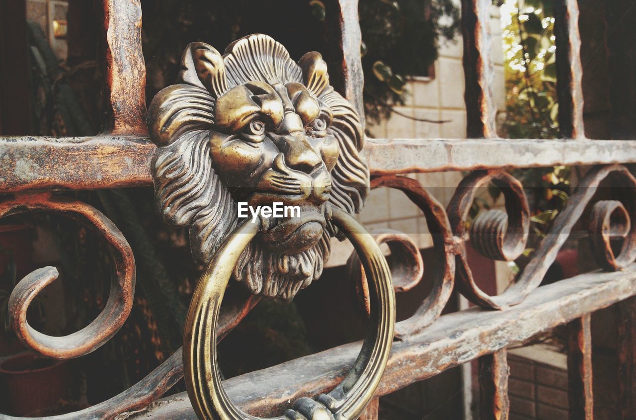 Close-up of old-fashioned door knocker on gate