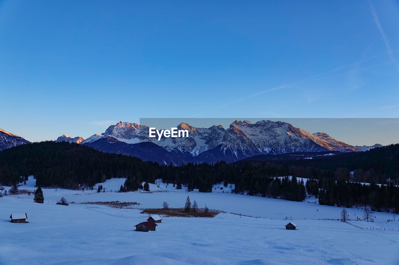 scenic view of snow covered mountains against clear blue sky